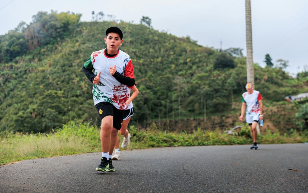 Teenagers enjoy a group jog on a picturesque mountainous road, embracing fitness and nature.