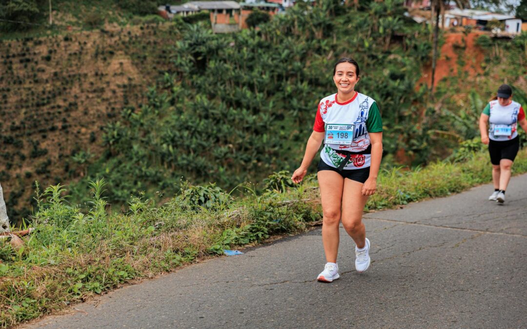 Woman enjoying an outdoor marathon with scenic countryside in the background.
