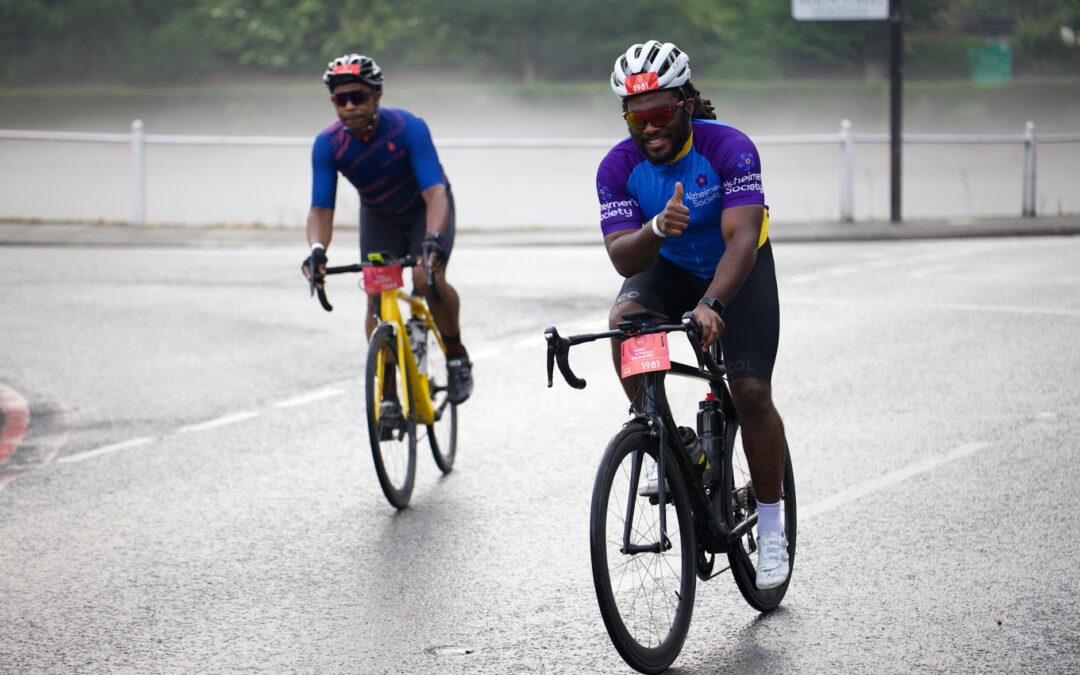 Cyclists participating in a joyful charity bike ride on a city road.