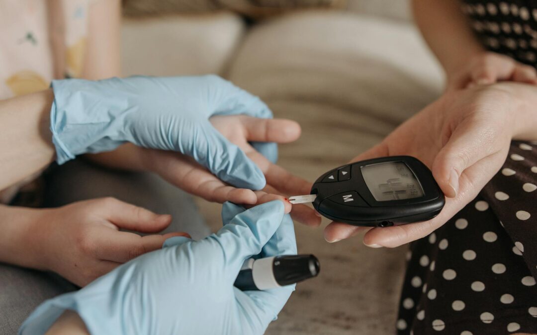 Hands measuring blood glucose levels with a glucose meter and test strip.