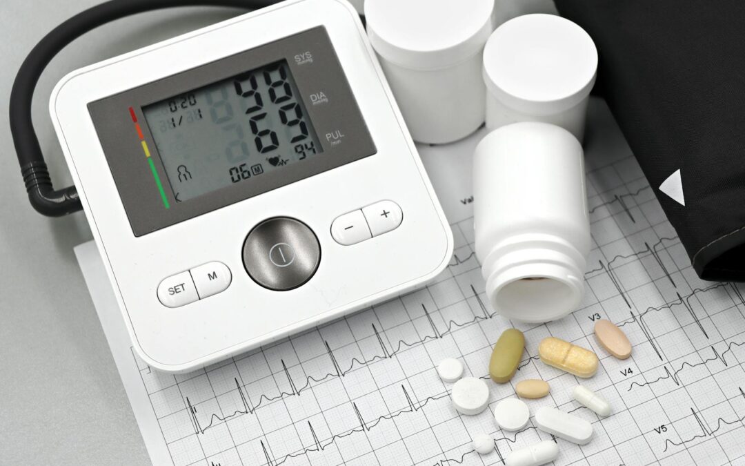 Blood pressure monitor with pills on ECG sheet, essential for heart health management.