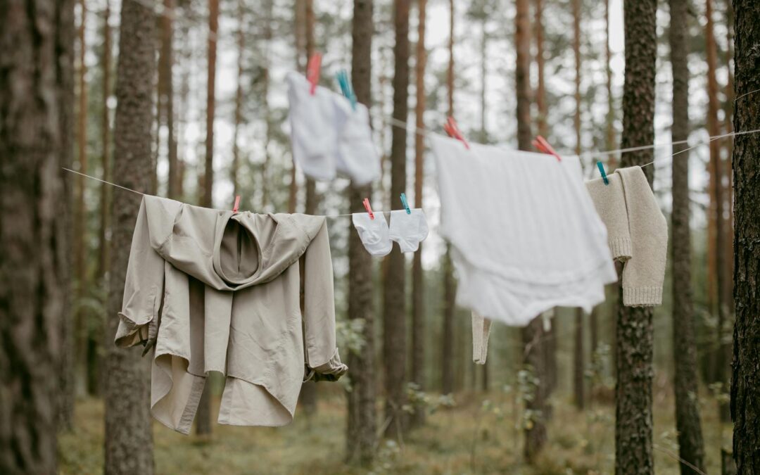 Clothes hanging on a line in a serene forest, creating a rustic outdoor laundry scene.
