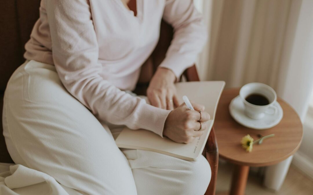 A person journaling in a cozy room with a cup of coffee. Warm and inviting atmosphere.